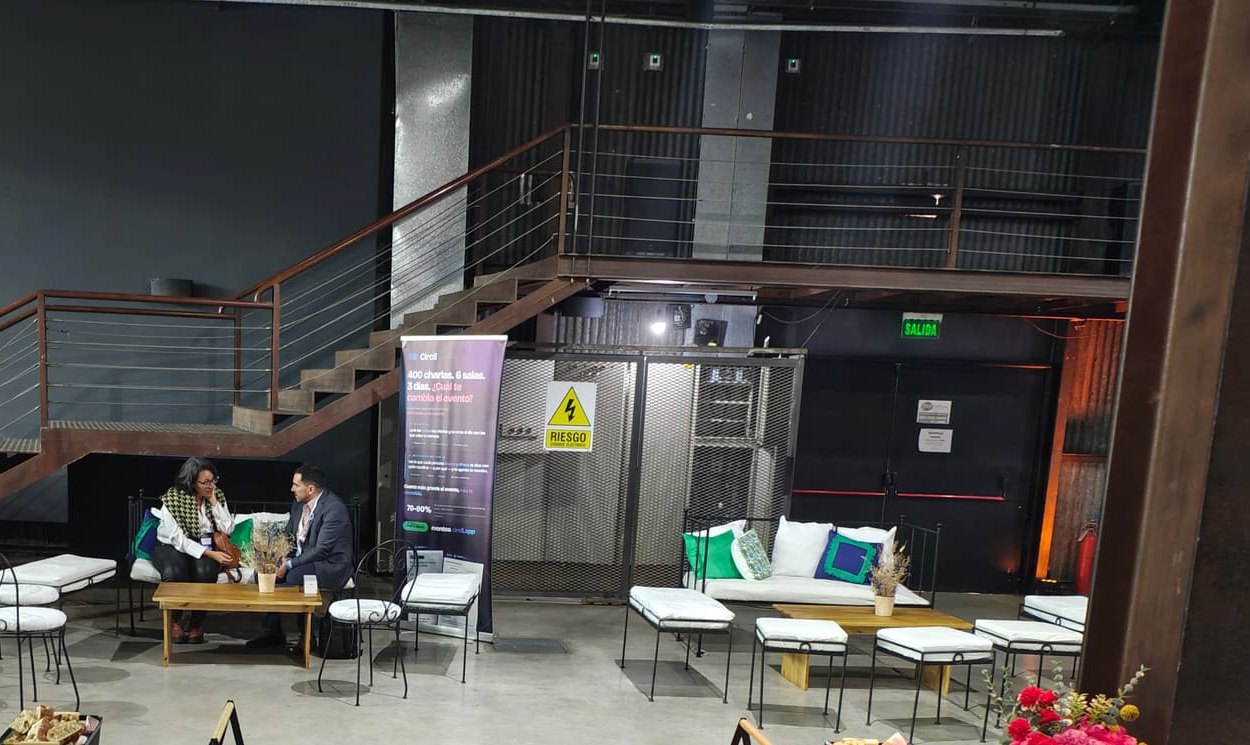 Networking area with sofas and two people meeting at a low table